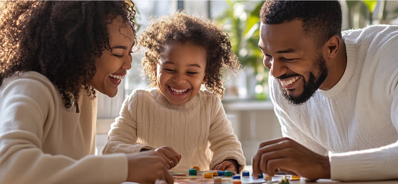 Happy family playing board game